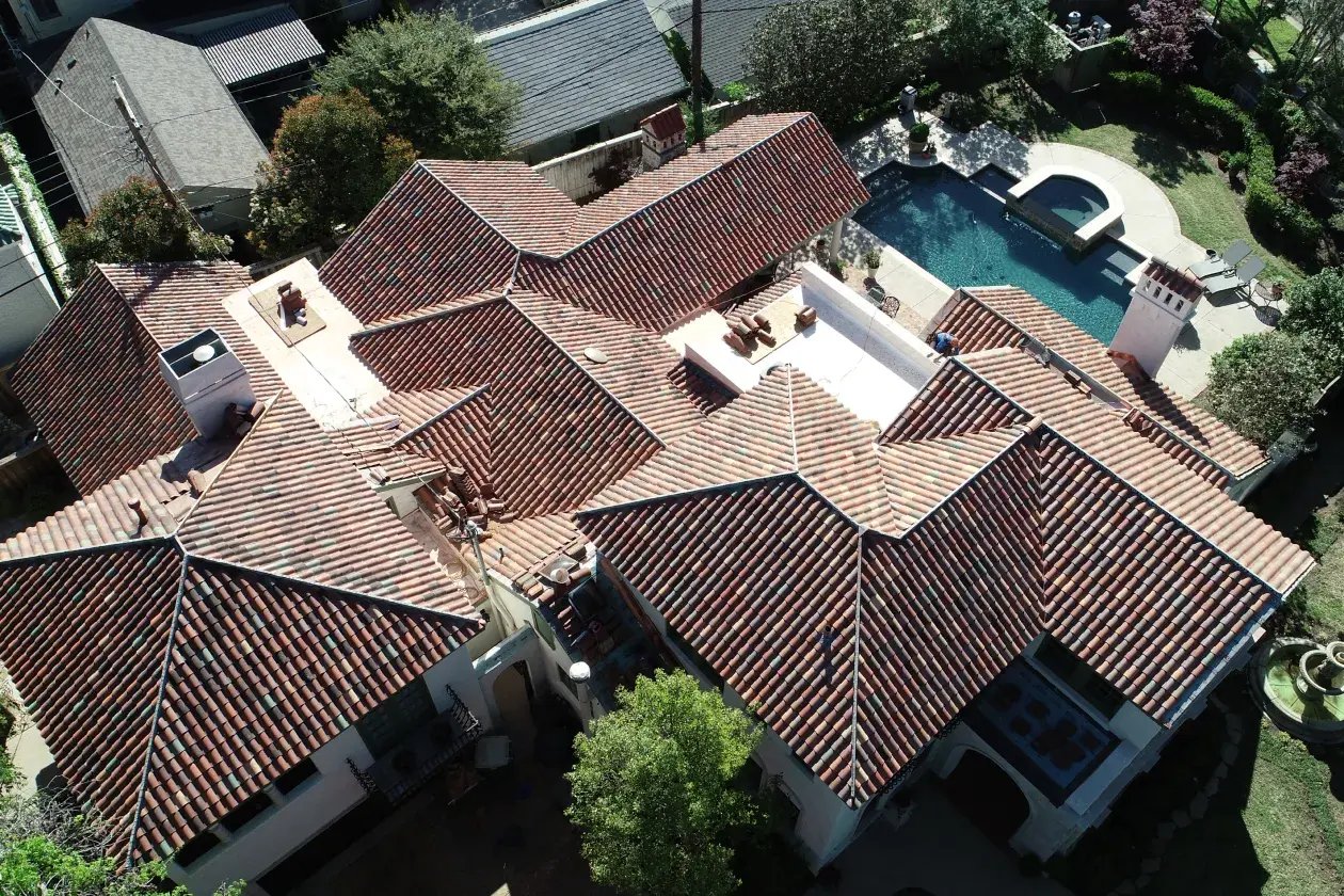 Large home with tile roof and backyard pool.