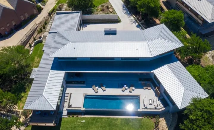 Aerial view of large home with pool. 